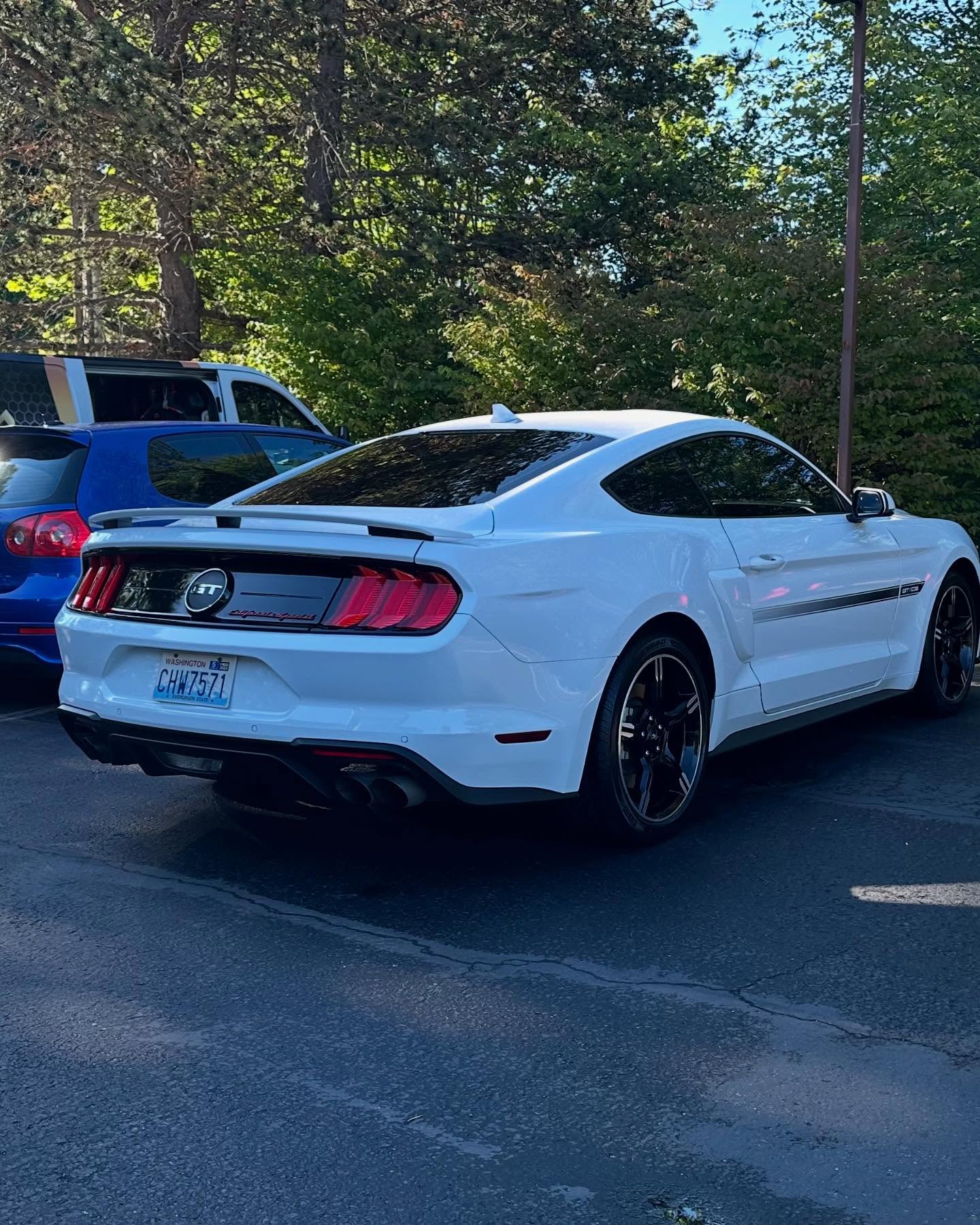 Customer vehicles outside OS Pro Auto Detailing's paint protection film shop in Bellevue, WA