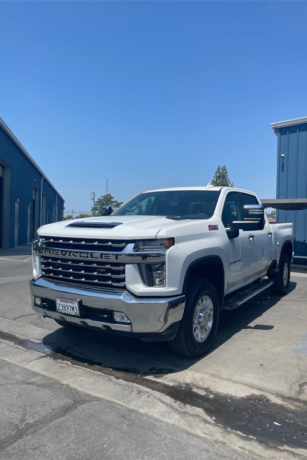 A heavy-duty pickup truck parked outdoors after a full exterior detailing treatment.