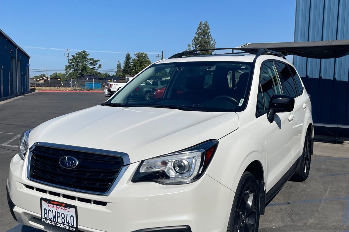 Close-up of a vehicle’s hood reflecting the sky, demonstrating the clarity of a premium PPF.